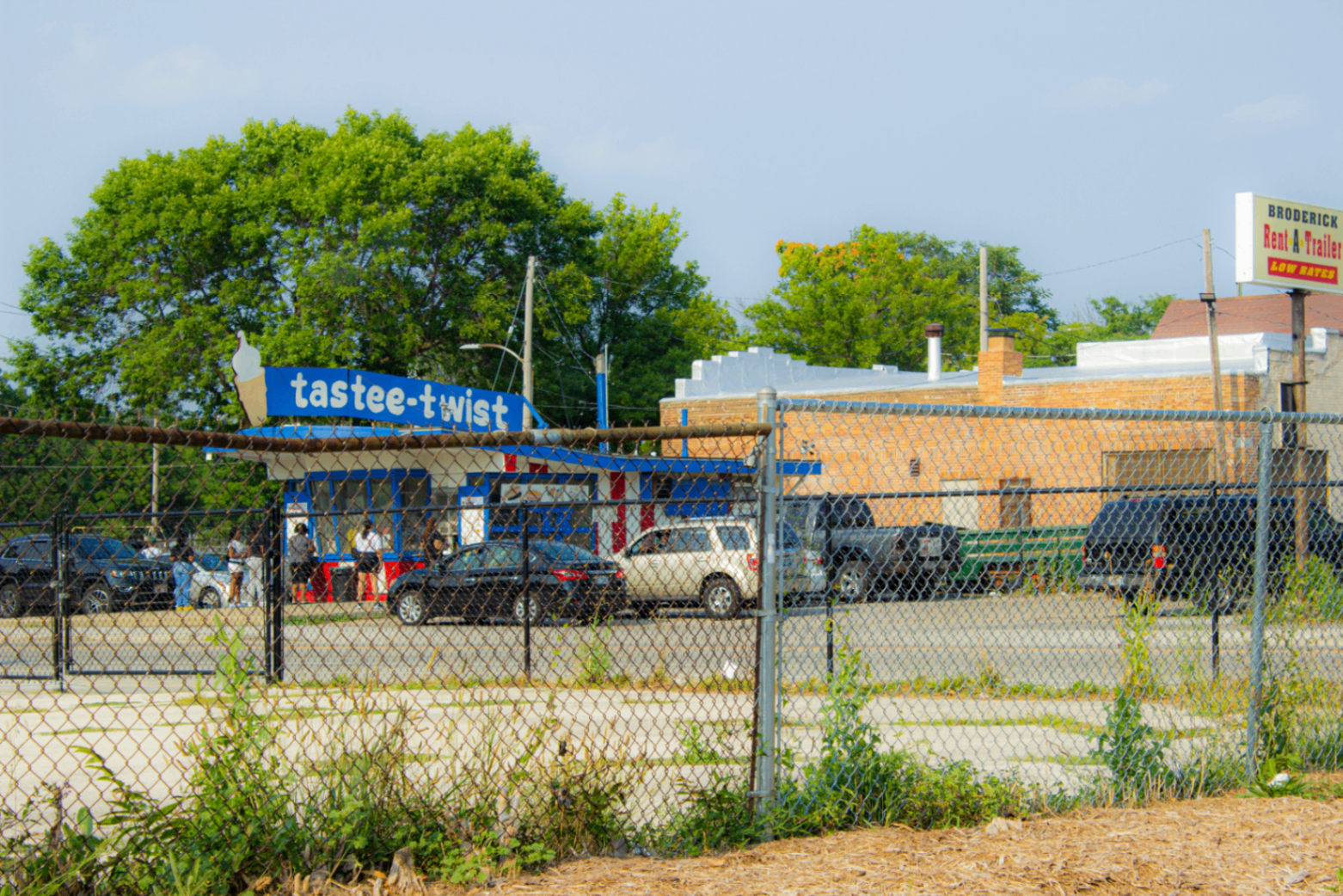 Tastee-Twist ice cream stand seen through a chainlink fence