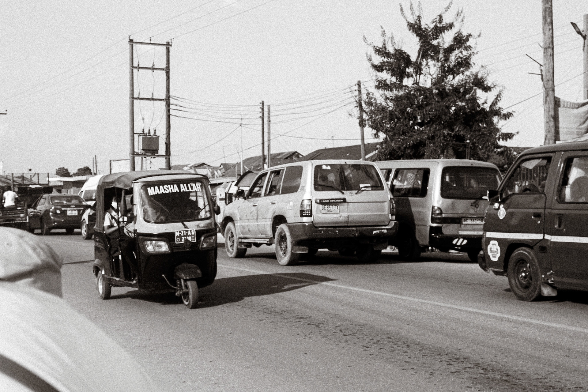 Tuk-tuk reading Maasha Allah threading through Accra traffic