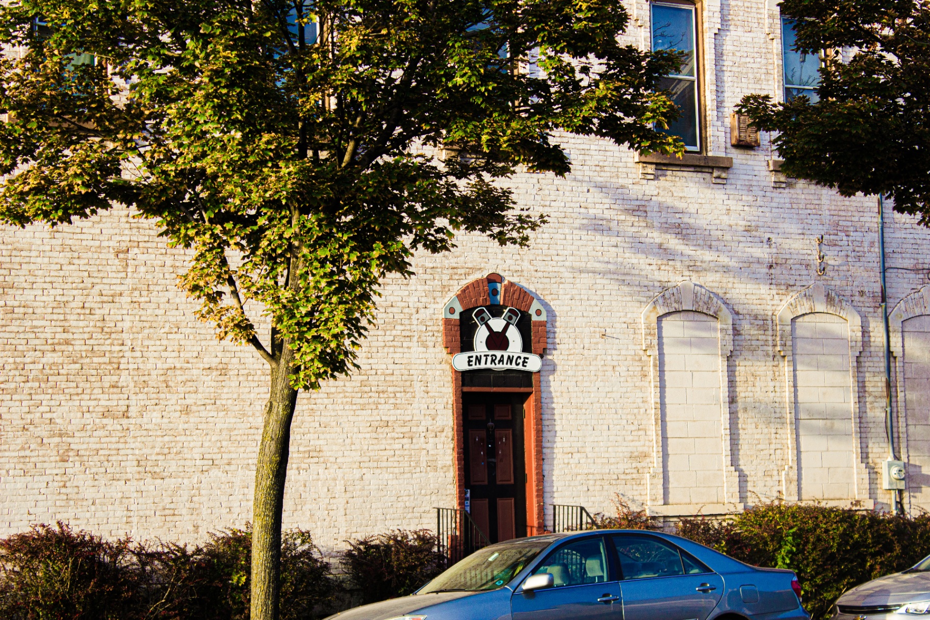 Painted entrance doorway on a white brick warehouse